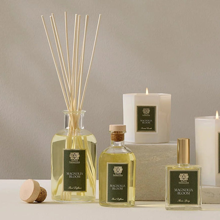 Set of diffusers, candles, and bottles on a neutral background